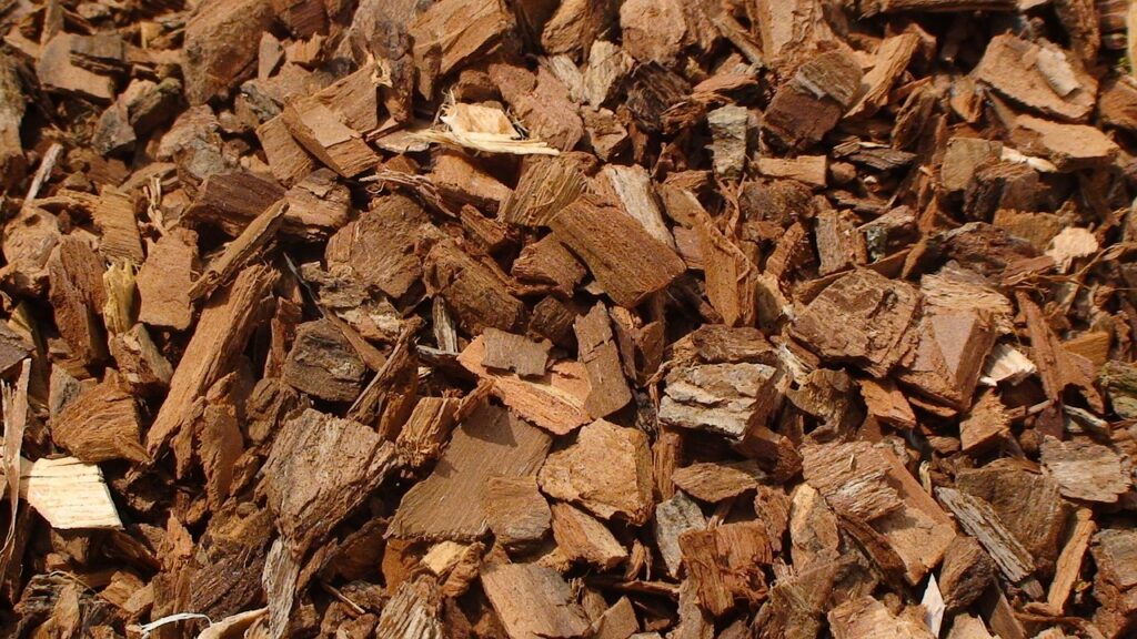 a pile of wood chips in a field