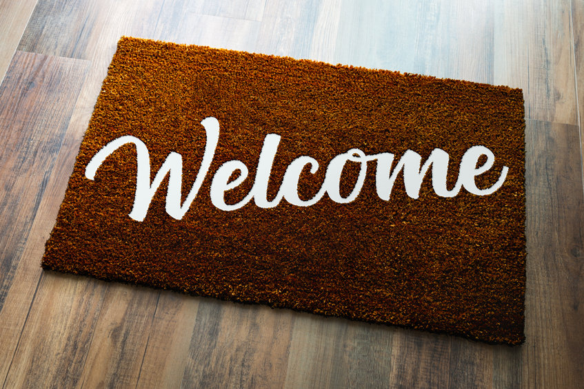 welcome mat on wooden floor