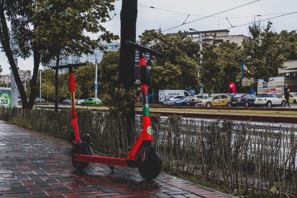 a red scooter on a sidewalk