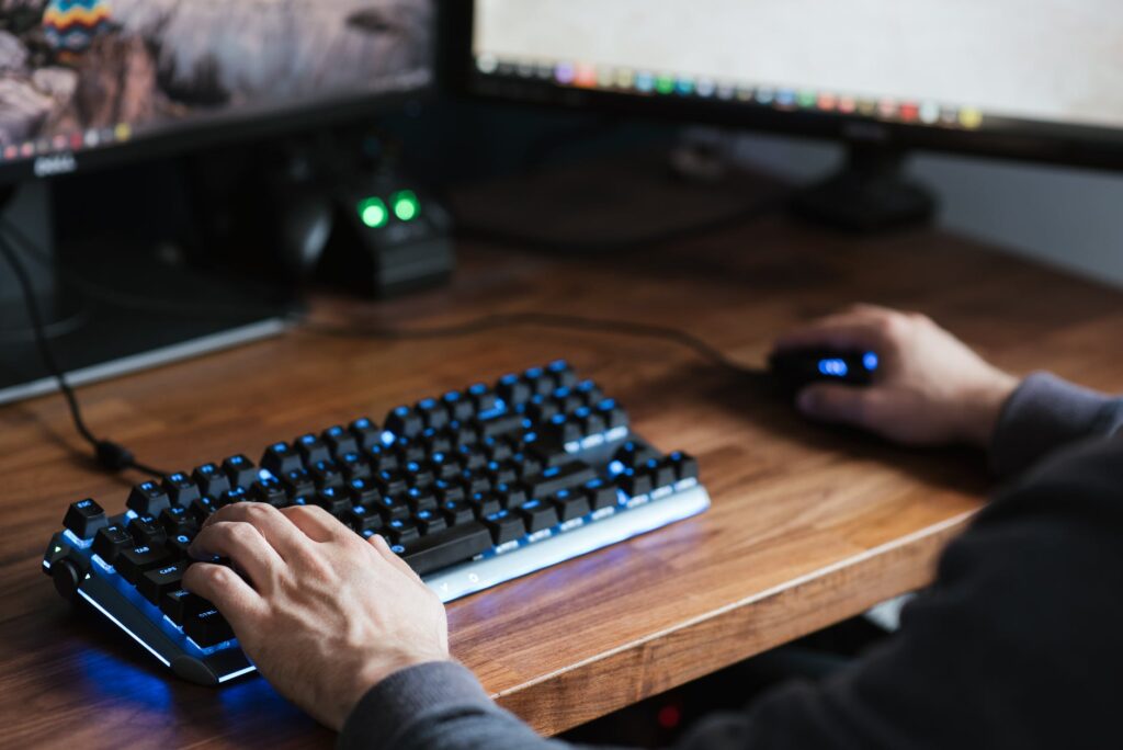 a person is using a computer keyboard and mouse