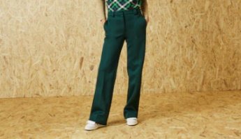a woman in green pants and a plaid shirt