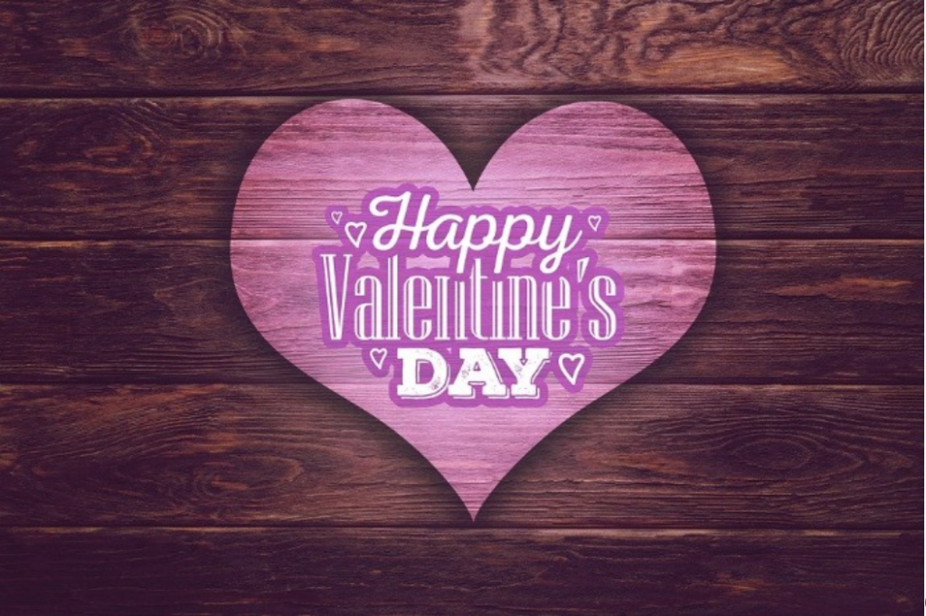 happy valentine's day text on wooden background