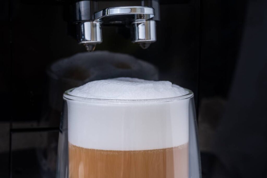 a coffee machine is making a latte