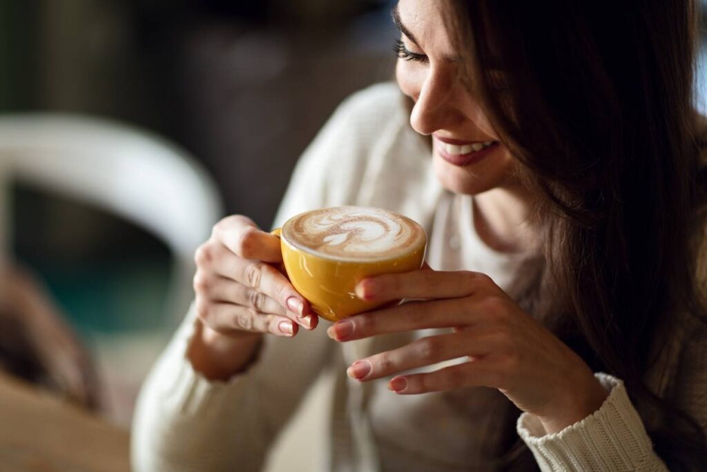 a woman holding a cup of coffee