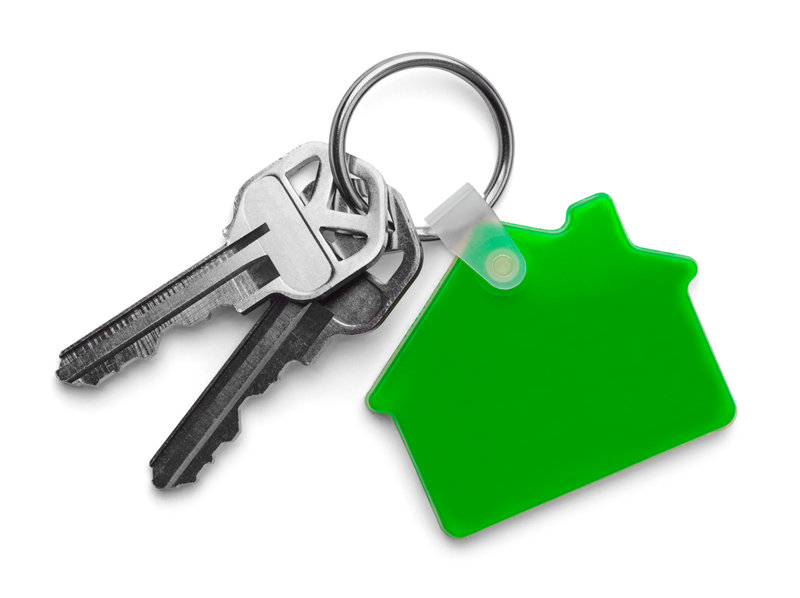 a green house keychain with two keys and a house shaped tag
