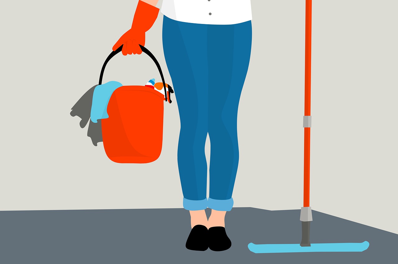 a woman in a blue shirt and red gloves is holding a bucket and mop