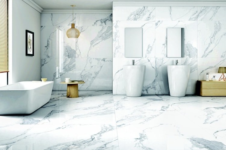 a bathroom with marble flooring and white walls