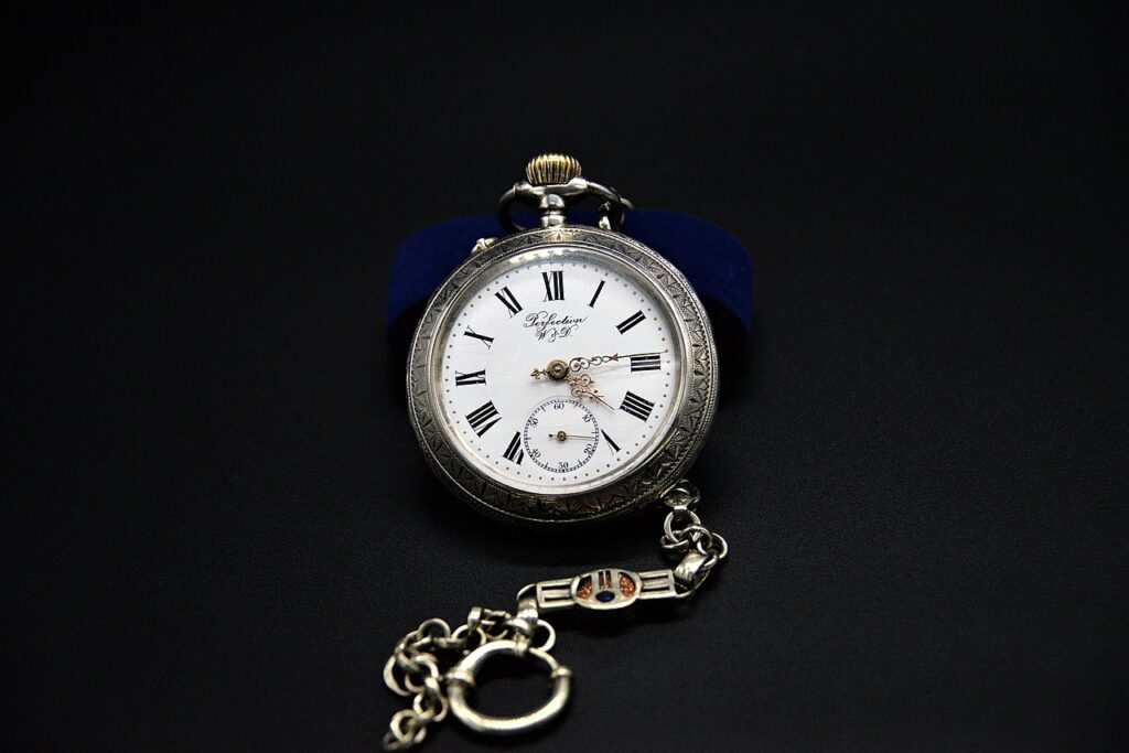 an antique pocket watch with a chain around it